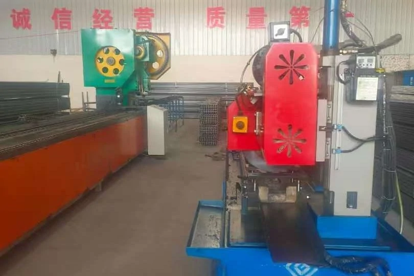 Hydraulic press with a red safety guard forming a steel channel on its bed