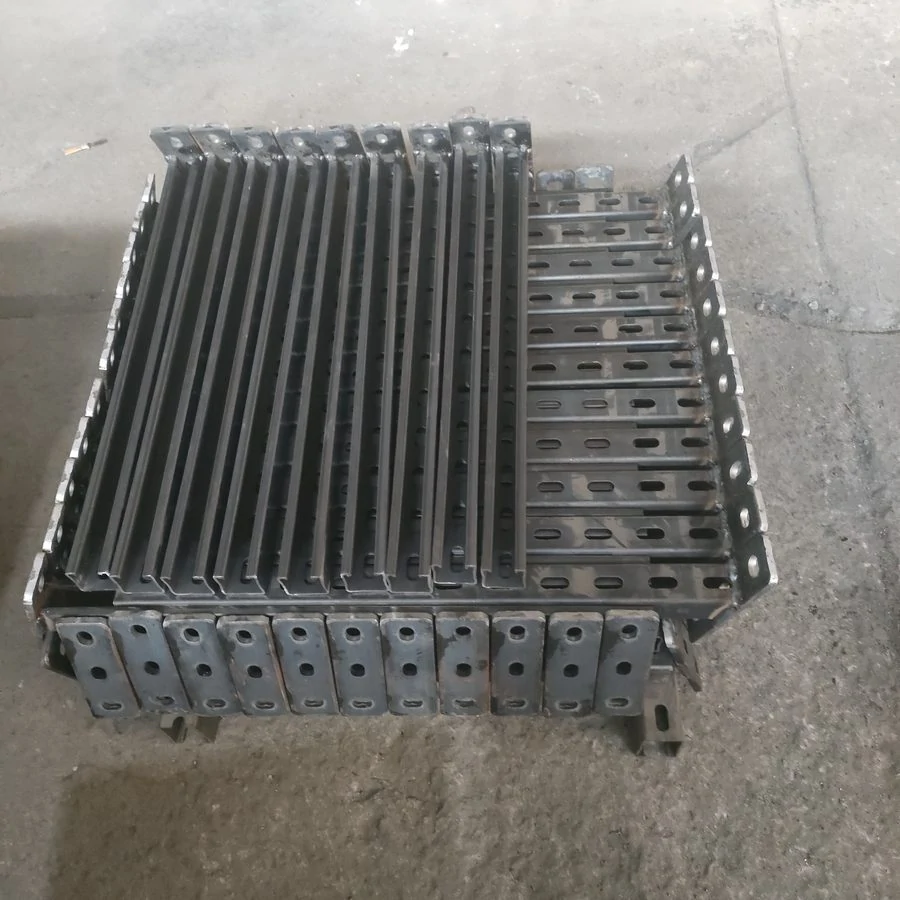 Neat stack of galvanised slotted bracket parts photographed from above on the factory floor