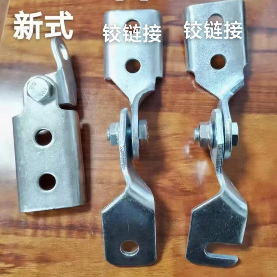 Three galvanised hinge-link seismic brace fittings laid out on a workbench